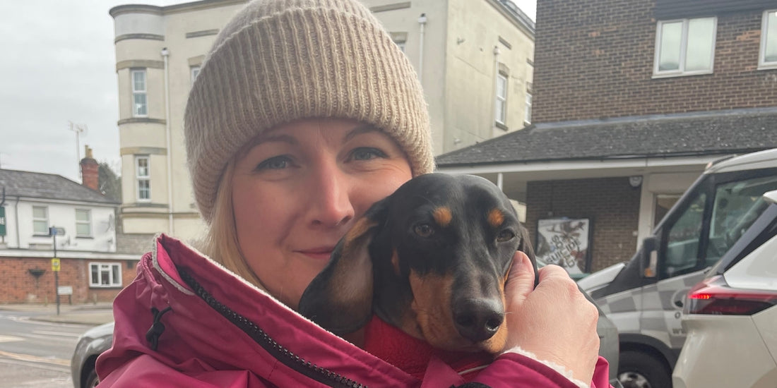 Cuddling a sausage dog while in a sundfoerr change robe